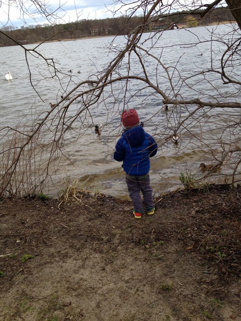 REAR VIEW OF BOY WALKING ON SNOW