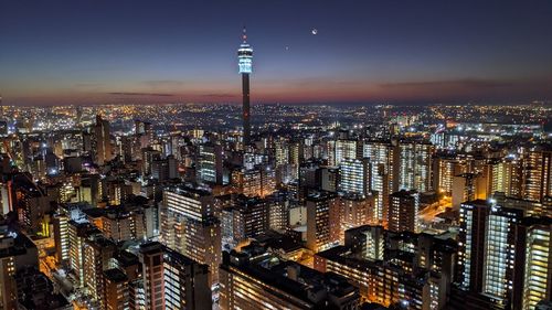 Johannesburg city skyline. aerial view of illuminated buildings in city at night.