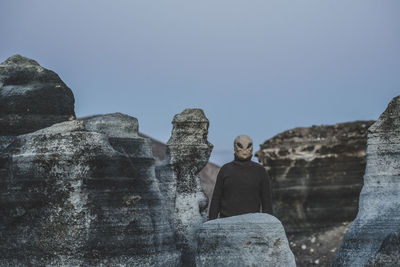 Low angle view of rock formations against clear blue sky