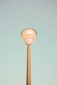 Low angle view of light pole against clear sky