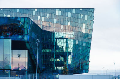 Digital composite image of modern building against sky