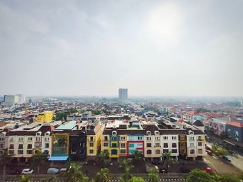 High angle view of buildings in city against sky