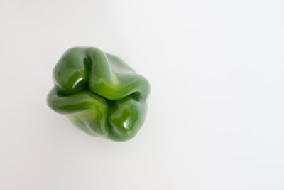 Close-up of green chili pepper against white background