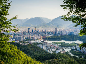 High angle view of townscape by mountains against sky