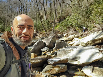 Portrait of man standing in forest