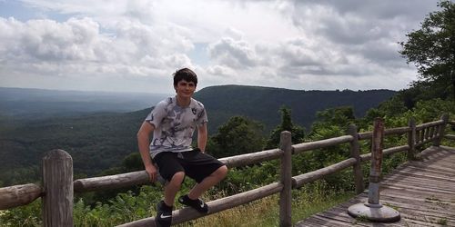 Full length of man on railing against mountains