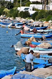 Rear view of people on boat in sea