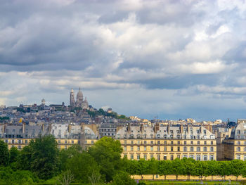 Cityscape of paris, france, with sacre couer in montmartre with cloudy sky