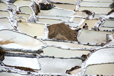 High angle view of man sitting at salt flat