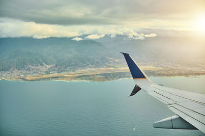 Cropped image of airplane wing against sky