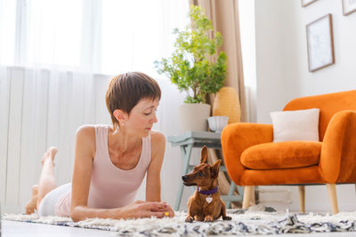 Concept healthy lifestyle. yoga and fitness. cute woman with small dog