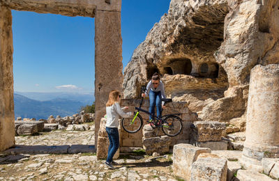 Friends by old ruins against mountain