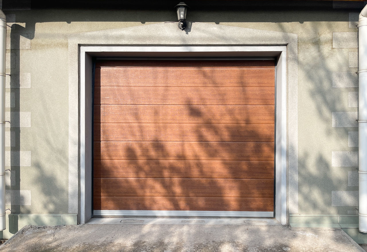 architecture, built structure, building exterior, door, facade, interior design, wood, window, no people, window covering, wall, building, garage door, entrance, day, sunlight, closed, wall - building feature, shadow, outdoors, home, house, city, residential district, shutter