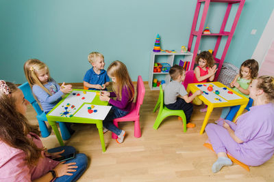 High angle view of kids playing at classroom