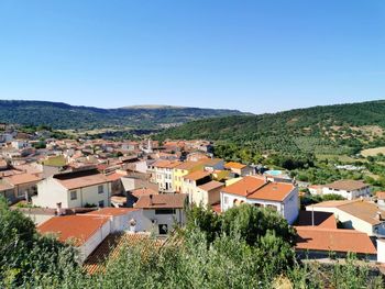 Village of siligo against hills and clear blue sky