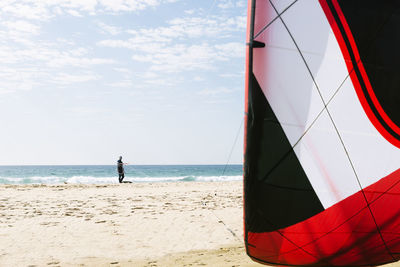 People on beach by sea against sky