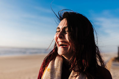 Portrait of smiling young woman on beach