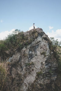 Low angle view of rock formation against sky