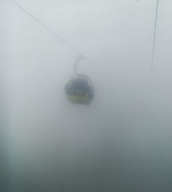 Overhead cable car in foggy weather