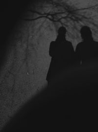 Shadow of people on street at night