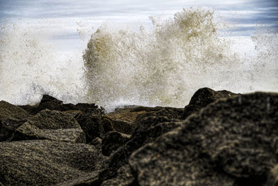 Waves splashing on rocks at shore