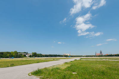 Scenic view of field against blue sky
