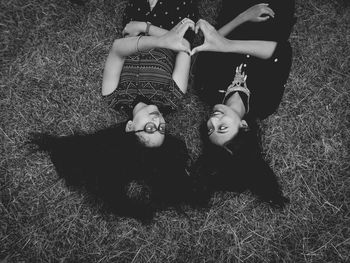 High angle view portrait of happy girl lying on field