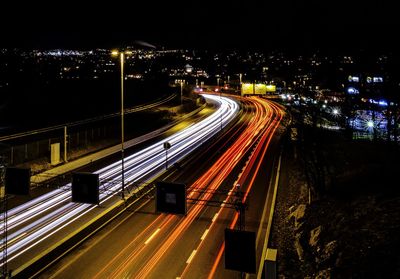 High angle view of light trails on road at night