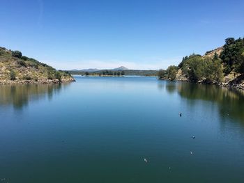 Scenic view of lake against blue sky