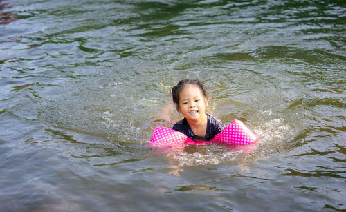 Portrait of girl swimming in lake