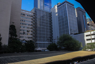 Modern buildings in city against sky