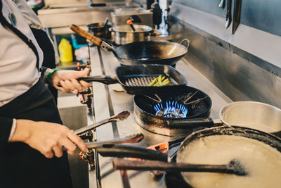 Midsection of man preparing food in kitchen at home