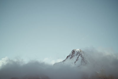 Low angle view of snowcapped mountain against sky