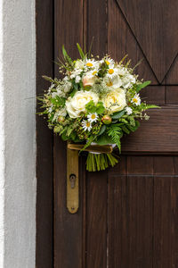 Close-up of white flowering plants on wooden door