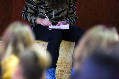 Rear view of people sitting on the wall