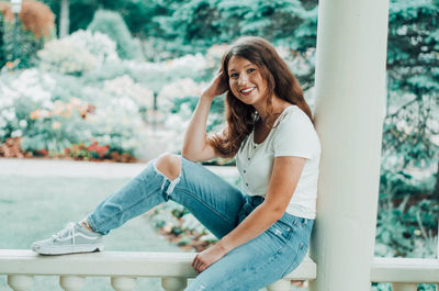 Young woman smiling while sitting outdoors