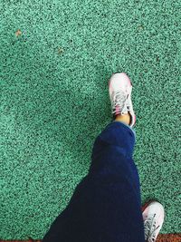 Low section of woman standing on grass