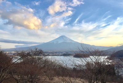 Scenic view of snowcapped mountain against cloudy sky