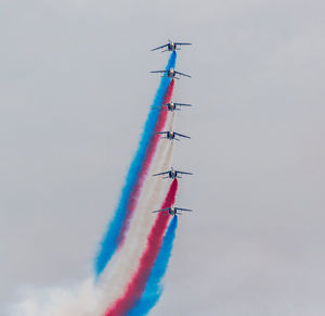 Low angle view of airshow against sky