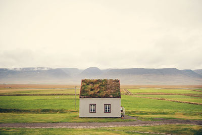 Built structure on landscape against sky