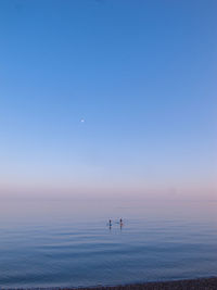 Scenic view of sea against clear sky at sunset