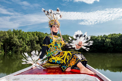 Portrait of woman sitting on boat in lake