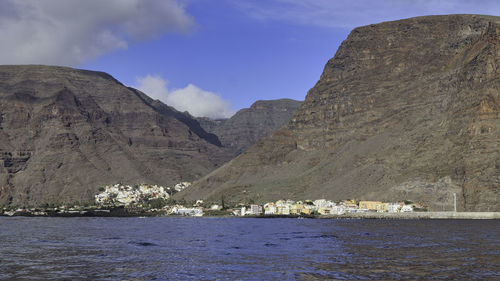 Scenic view of sea and mountains against sky