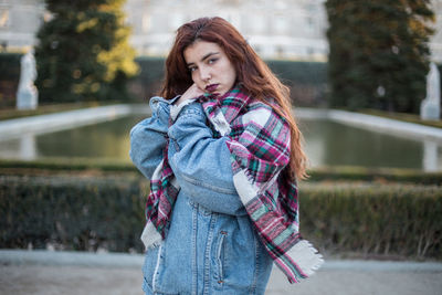 Portrait of beautiful young woman standing outdoors