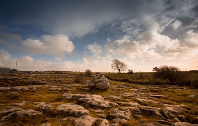 Scenic view of rocks on field against sky