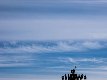 Low angle view of statue against cloudy sky