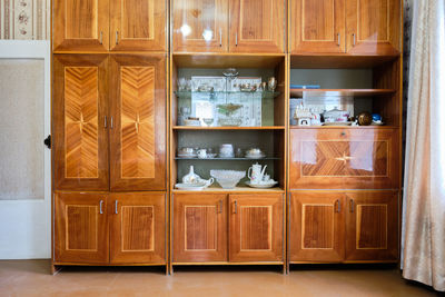 Old soviet  poor interior in khruschev house. aged sideboard.  shabby floor. tattered wallpaper. 