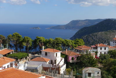 High angle view of townscape by sea against sky