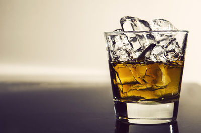 Close-up of whiskey glass on table