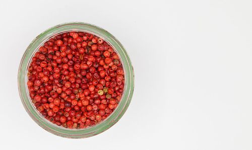 High angle view of strawberries in bowl against white background